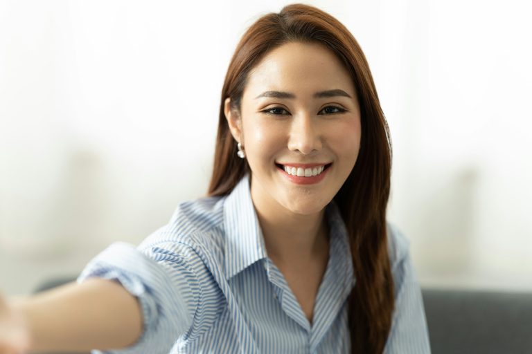 Young asian woman taking selfie. webcam and video conference concept.